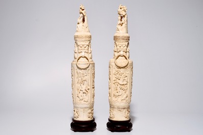 A pair of tall Chinese ivory vases and covers on wooden base, early 20th C.